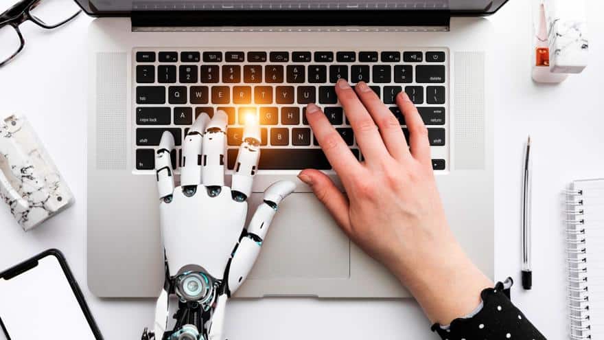 Keywords:
Robot hand typing on laptop - The Ultimate AI SEO Guide for 2025