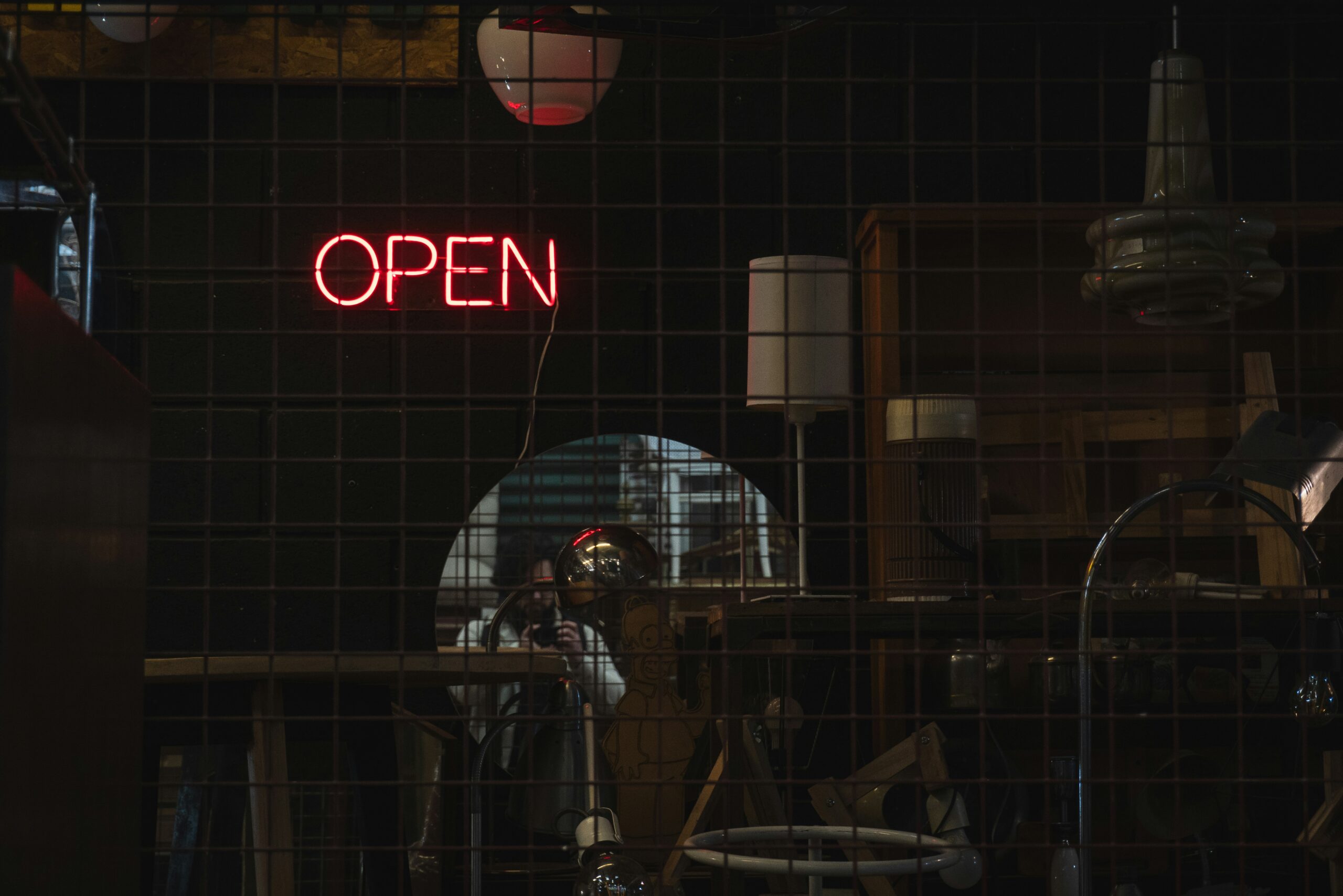 Open lock on digital background - Neon open sign illuminates a dark room.