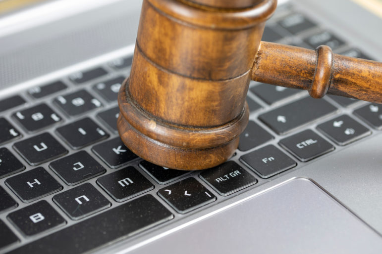 Gavel on computer keyboard - SLAPP Fight: How Journalists Are Pushing Back on Nuisance Lawsuits ...